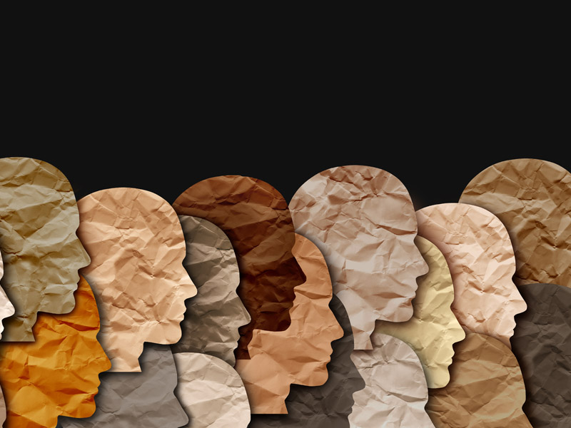 Image of paper heads ranging in different shades of white, brown, and black