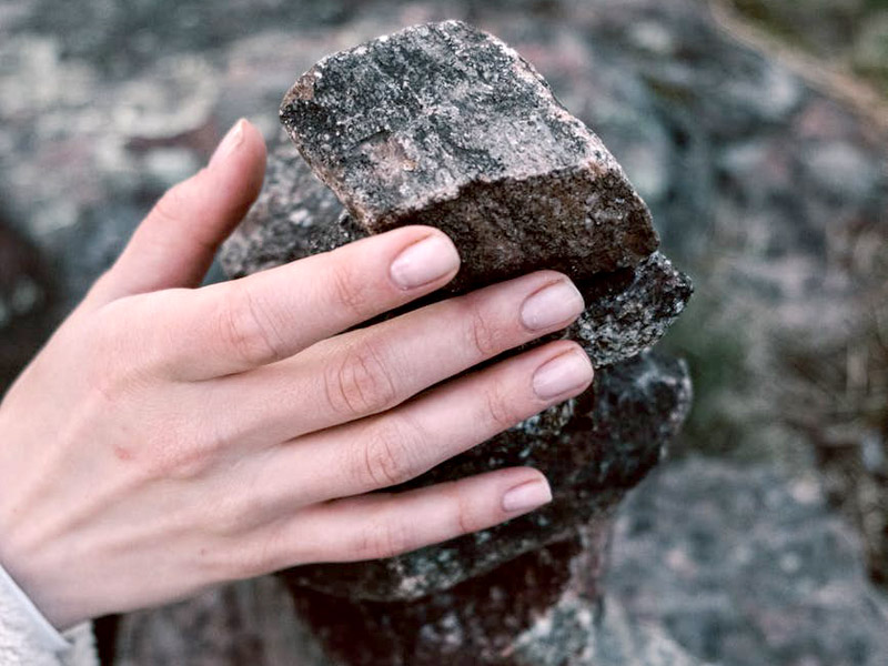 Photo of Woman Holding a Rock