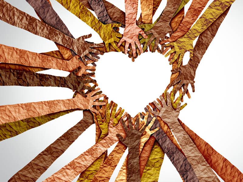 Diverse hands and arms (made out of tissue paper) coming together to form a heart.