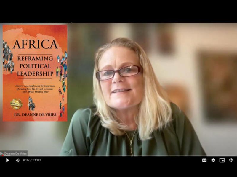 Screenshot of Author Deanne Michelle De Vries with the cover of her book Africa: Reframing Political Leadership.