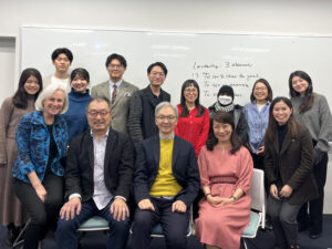 Photo of ILA President Cynthia Cherrey sitting with ILA members from Waseda University and other universities in Japan.