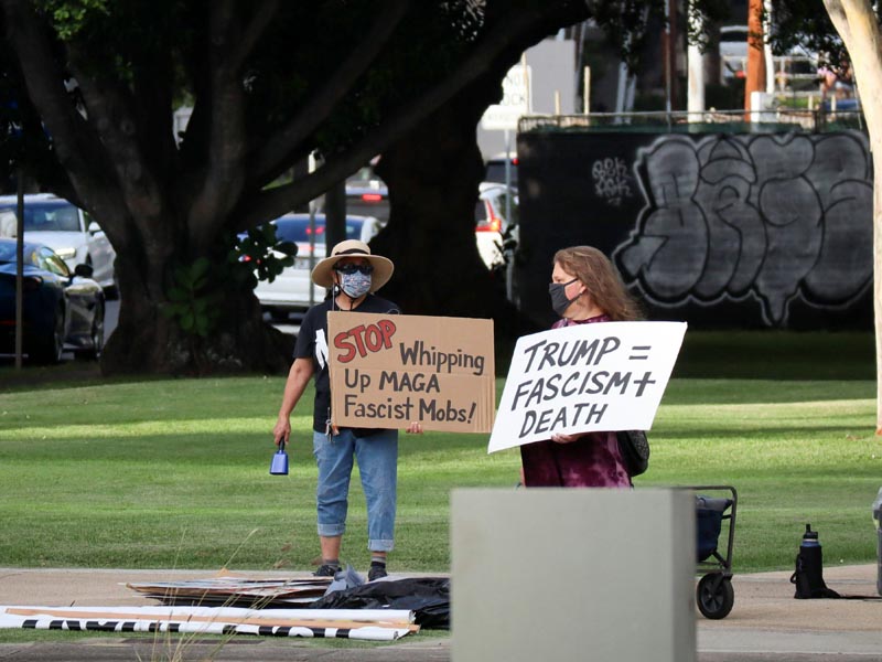 Protestors holding signs "Trump=Fascism + Death" etc.