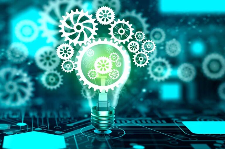 Image of lightbulb with cogs against a computer chip backgrounds with floating cogs.